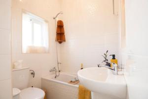 a white bathroom with a sink and a toilet at Maltese Charm - Seaside Stay - Table Soccer in St. Julianʼs +56 photos