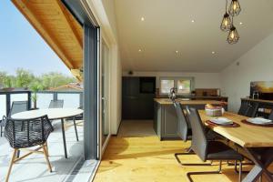 a kitchen and dining room with a table and chairs at "Penthouse Suite" mit Whirlpool Romantik und Privatsphäre in Rosenheim +19 photos