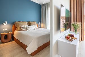 a bedroom with a bed and a blue wall at Let's Sea by 2HomeRent in Gąski +204 photos
