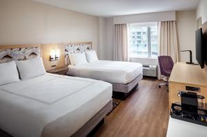 a hotel room with two beds and a desk at Hampton Inn & Suites by Hilton Miami Downtown/Brickell in Miami +31 photos