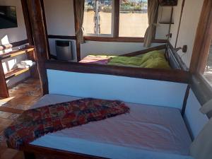a small room with a bed and a window at Camino & Piedra 2 - Cabaña de montaña in Potrerillos +3 photos