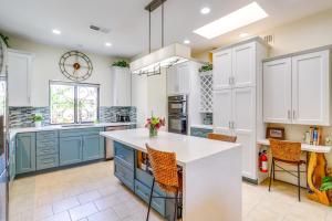 a kitchen with blue and white cabinets and a counter at Resort Pools and Golf Palm Springs Condo! in Cathedral City