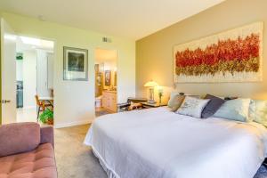 a bedroom with a large white bed and a couch at Resort Pools and Golf Palm Springs Condo! in Cathedral City +33 photos
