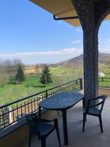 a table and chairs on a balcony with a view at La Quiete in Caraglio