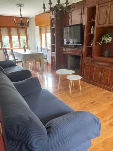 a living room with a blue couch and a table at Casa El Hoyuco in Lamadrid