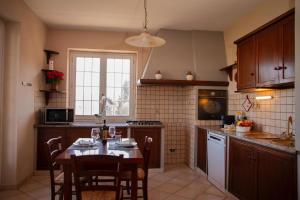 a kitchen with a table and some chairs and a table and a kitchen with at La Quiete in Caraglio