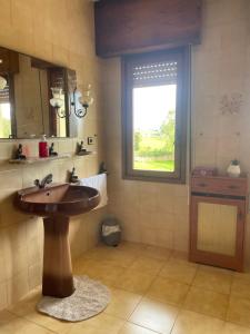 a bathroom with a sink and a window at Casa El Hoyuco in Lamadrid +24 photos