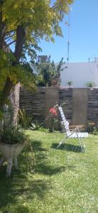 a chair sitting in the grass in a yard at Casa Ariana I in Federación +3 photos