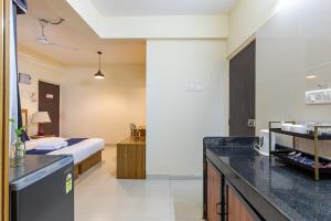 a hotel room with a bed and a kitchen at Golden Waves Holidays in Anjuna