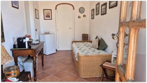 a bedroom with a bed and a desk in a room at La Cava di Sasà in Favignana
