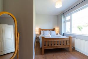 a bedroom with a bed and a large window at Inch by the Sea - Sea Views in Inch