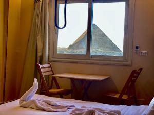 Voodi või voodid majutusasutuse Moonlight pyramids view INN toas