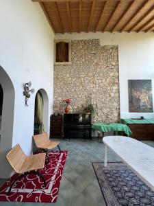 a living room with a stone wall and a piano at Villa in Valpolicella in San Pietro in Cariano