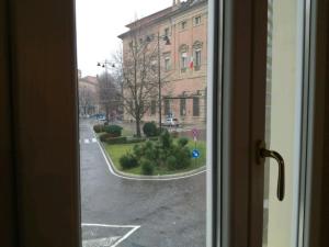 a view of an empty street from a window at TRIBUNALE 4 LUXURY Rooms - BEDinBOLOGNACENTRO PALACE H in Bologna +2 photos