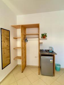 a room with a kitchen with a refrigerator and shelves at Ocean Life Dahab in Dahab