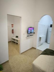 a white room with a tv on a wall at Amalia Apartment in Lisbon +16 photos