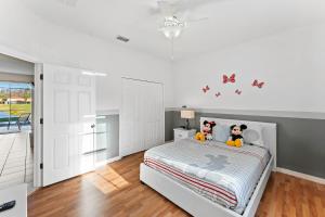 a bedroom with a bed with two stuffed animals on it at 4BR Townhome with Lake View – BL481 in Kissimmee