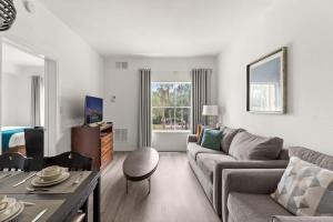 a living room with a couch and a table at 1BR FREE Shuttle to Disney Parks HS305 in Orlando
