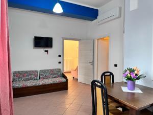 a living room with a couch and a table at Appartamento "Rosa" in Casal Velino