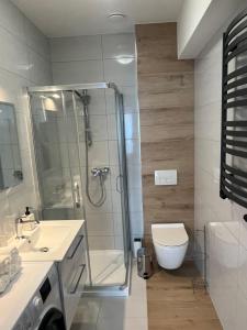 a bathroom with a shower and a toilet at MC Apartamenty Ściegiennego 3 in Augustów +20 photos
