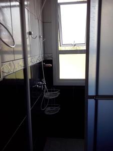 a bathroom with a shower and a window in it at Casa Deni in Nova Petrópolis +60 photos