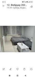 a room with a bed and a coffee table at Lenka 2 in Sremska Mitrovica