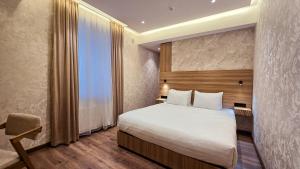 a hotel room with a bed and a window at Hotel Bankir Khiva in Khiva