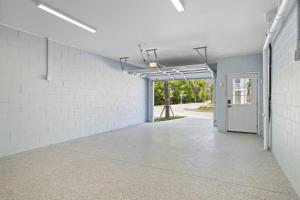 an empty room with a white brick wall and a door at Brand New LUX Townhome-Mins to Beaches, Game Room! in Hilton Head Island