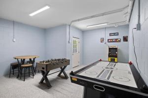 a play room with a ping pong table and a ping pong table at Brand New LUX Townhome-Mins to Beaches, Game Room! in Hilton Head Island