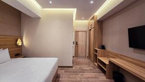 a hotel room with a bed and a flat screen tv at Hotel Bankir Khiva in Khiva