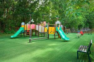 a park with a playground with a slide at Swiss Court Holiday Apartments in Lumut +6 photos