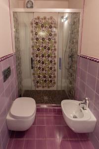 a bathroom with a shower and a toilet and a sink at Agave Residence House 12 in Pomarico