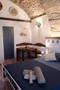 a bedroom with a bed with towels on it at Agave Residence House 12 in Pomarico