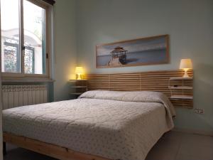 a bedroom with a bed and two lamps and a window at Turchese in Amalfi