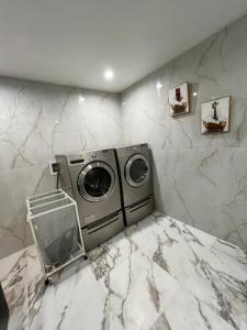 a washing machine in a room with marble walls at CampRV Main Lodge in Elkins