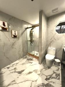 a bathroom with a toilet and a glass shower at CampRV Main Lodge in Elkins +42 photos