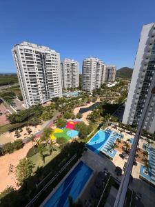 an aerial view of a resort with a beach and buildings at Ilha Pura Barra in Rio de Janeiro