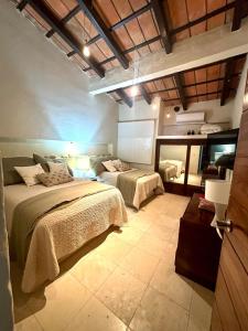a bedroom with two beds and a mirror at Penthouse Vallarta in Puerto Vallarta +33 photos