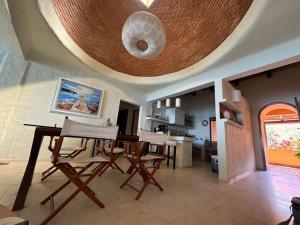 a living room with a table and chairs and a ceiling at Penthouse Vallarta in Puerto Vallarta