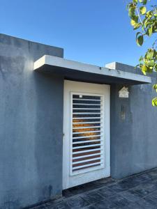 a door with a window on the side of a building at La Magallanes in Santiago del Estero