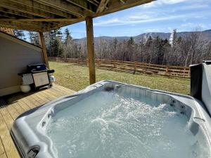 a jacuzzi tub on a deck with a view at SH5 Luxurious Stone Hill Townhome in Carroll