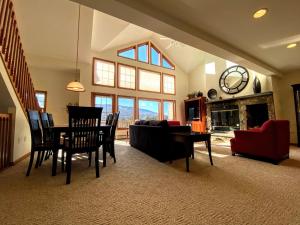 a living room with a table and chairs and a couch at SH5 Luxurious Stone Hill Townhome in Carroll