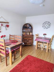 a dining room with a table and two chairs at Little Bassett Bed & Breakfast in Totland
