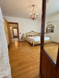a bedroom with a bed and a chandelier at Villa Gardenia - Comfort & Privacy - River View in Mira +57 photos