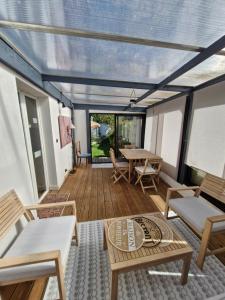 a screened in porch with a table and chairs at Gite Kerlaguito in Pontchâteau