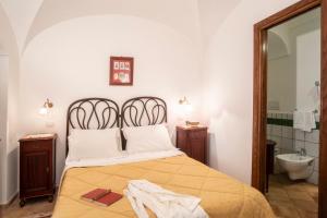a bedroom with a bed and a sink and a mirror at Torre Cangiani in Massa Lubrense +70 photos