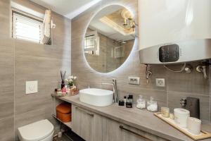 a bathroom with a sink and a mirror at Horizon Apartment Herceg Novi Savina in Španjola +20 photos