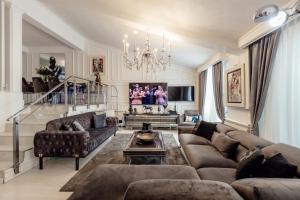 a living room with a couch and a chandelier at Horizon Apartment Herceg Novi Savina in Španjola