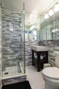 a bathroom with a shower and a toilet and a sink at Private Room at a shared Apartment at the Heart of East Village in New York