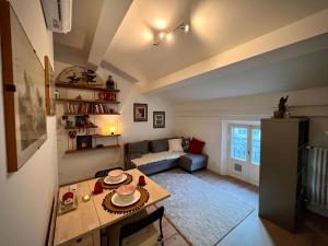 a living room with a table and a couch at Little Home Italy in Castelvetro di Modena